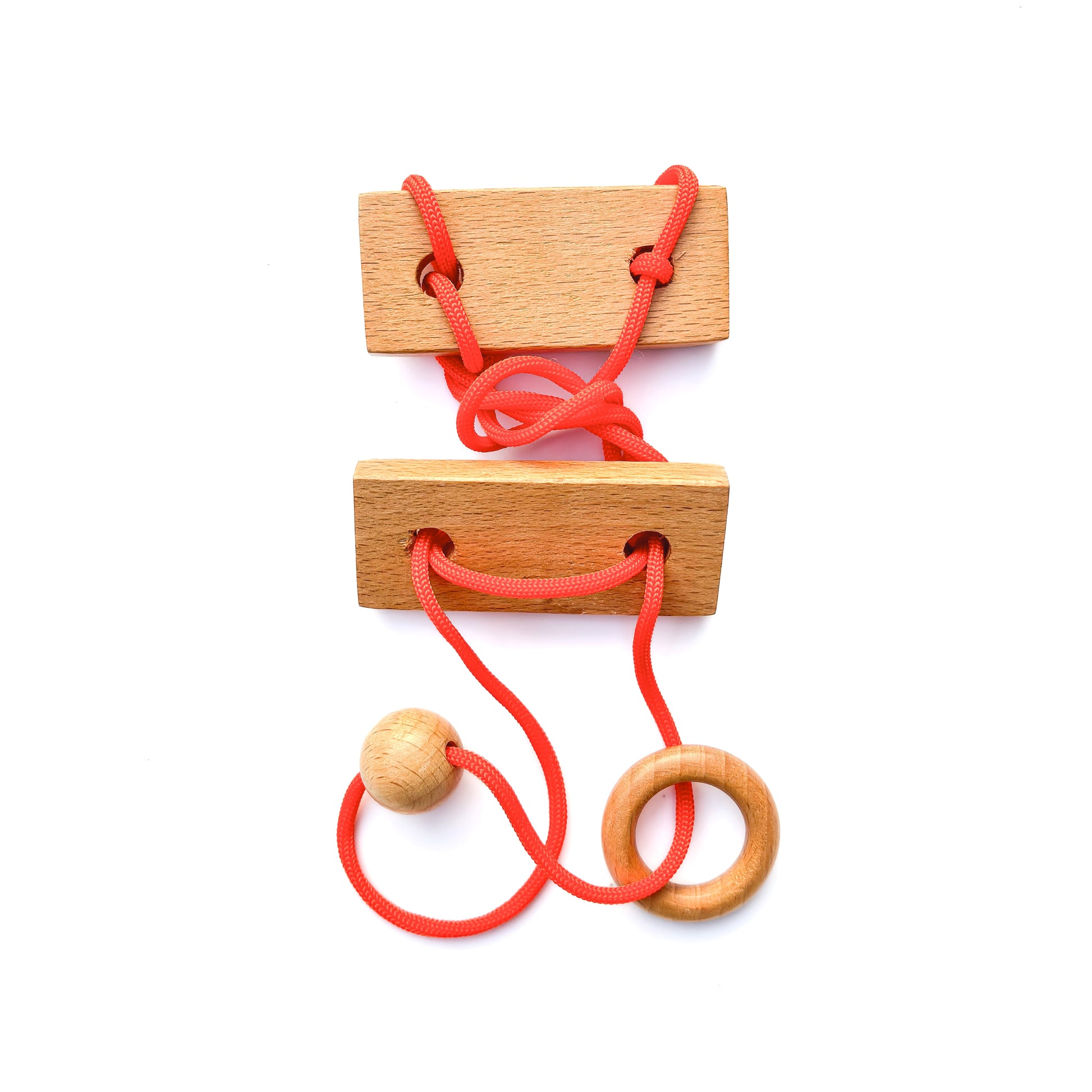 Wooden disentanglement String puzzle with red rope, ball, and ring on white background