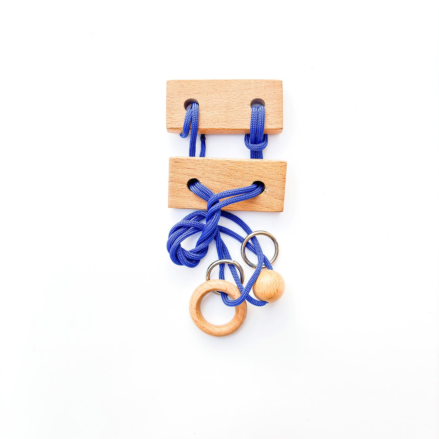 Wooden puzzle with blue rope and rings on a white background. This classic brain teaser toy challenges players to manipulate the rope to separate the rings from the puzzle