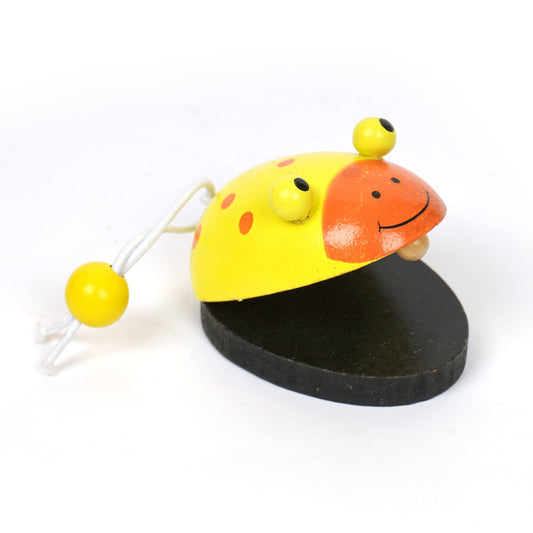 A yellow and orange wooden clapper shaped like a frog.