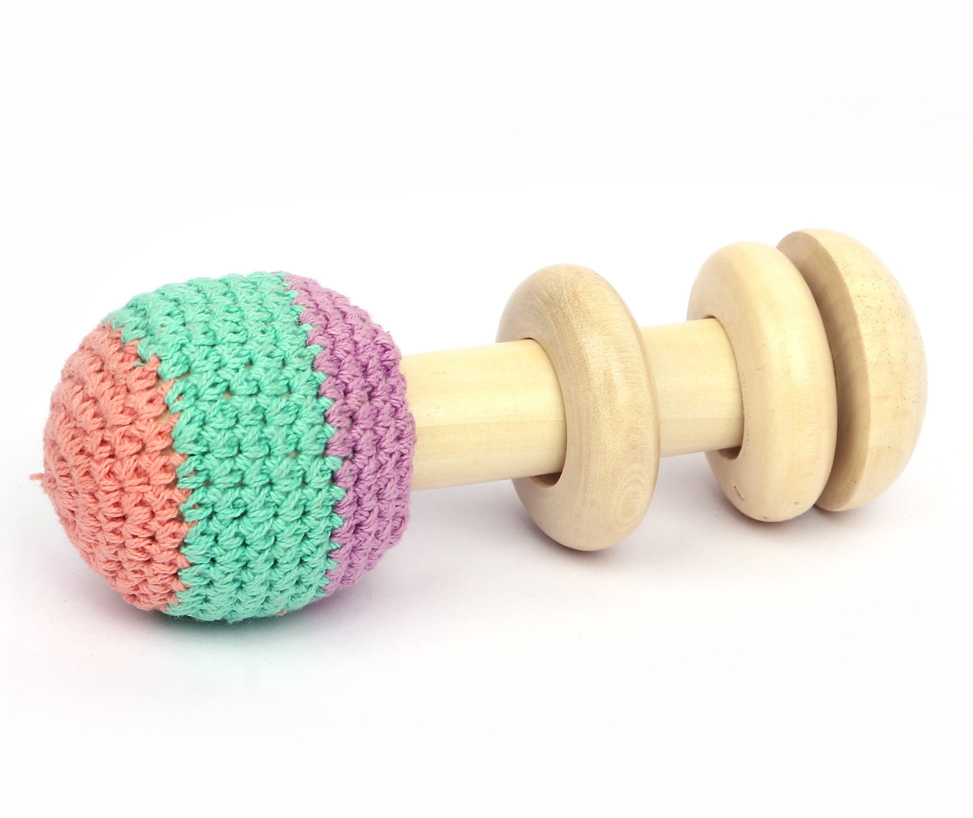 A wooden baby rattle with a crocheted ball on top. The rattle also has colorful wooden rings.