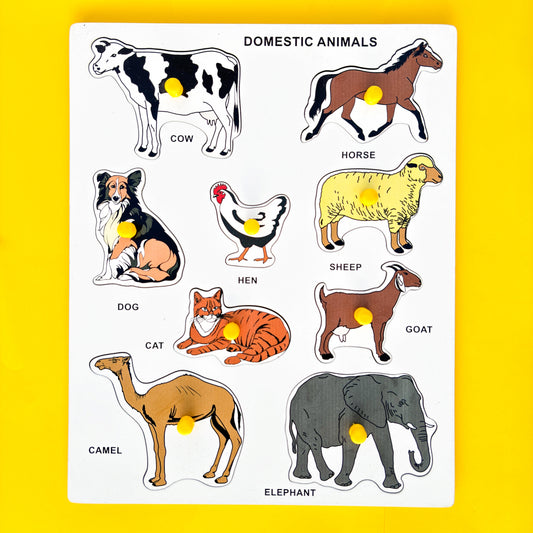 Wooden puzzle with colorful pictures of domestic animals on a yellow background. The text “DOMESTIC ANIMALS” is displayed at the top of the puzzle. Below the text, six animal names and their corresponding pictures are arranged in two rows.  In the first row, from left to right, are COW, HORSE, and HEN. In the second row, from left to right, are SHEEP, DOG, and CAT. Below these animals are GOAT and ELEPHANT.  This educational toy helps young children learn about different domestic animals. 