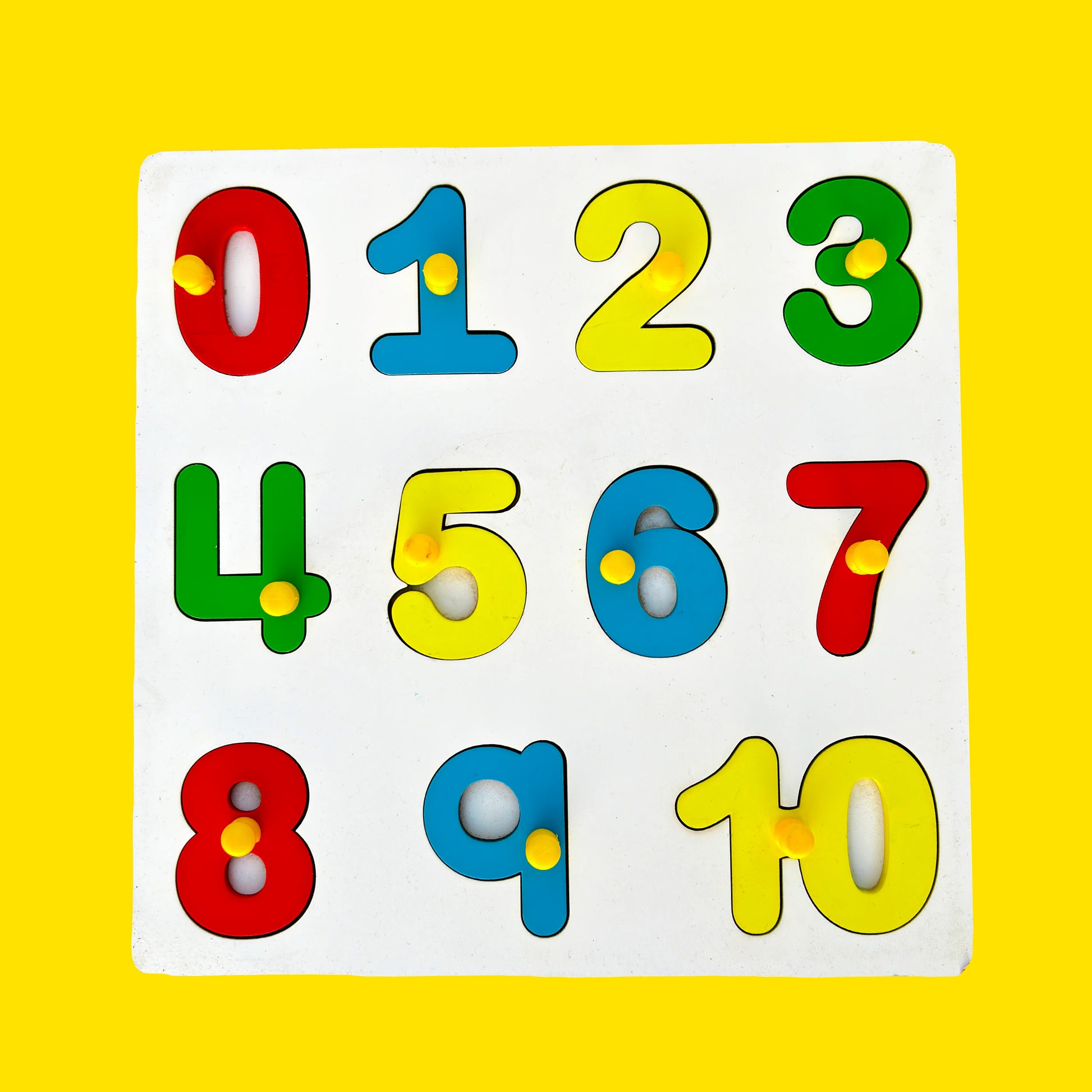 A colorful wooden number puzzle with knobs for toddlers. The puzzle features numbers one to ten (1-10) in various colors on a yellow background.